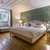 Santiago de Alfama - Boutique Hotel, Lisbon: elegant bedroom with king bed, patterned headboard wall and window seat