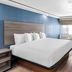 Baymont by Wyndham Arlington At Six Flags Dr guest room with king bed and sofa in Arlington