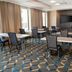 Residence Inn by Marriott Grand Rapids Downtown meeting room with tables, chairs, and wall-mounted TV