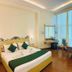 Hotel Devi Grand, Katra: spacious guest room with king bed, desk, armchair, and large windows with curtains