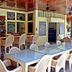 Mike's Dauin Dive Resort bar and dining area in Dauin with wicker chairs and glass tables