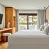 Nobu Hotel Marbella bedroom with king bed, balcony doors, and tropical garden view in Marbella