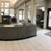 Residence Inn by Marriott Lincoln South lobby with curved sofa, fireplace, TV and high windows in Lincoln