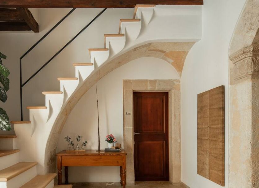 Can Joan Capo - Adults Only in Sineu, elegant interior with curved staircase, arched doorway and wooden table