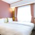 Toyoko Inn Kobe Minatogawa Koen guest room with two single beds and large window in Kobe
