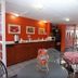 Hotel Camba Oaxaca breakfast room with red walls, checkered tables and buffet counter