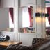 Bajamar Beach Hotel in Formia lounge with tufted leather sofas, mirrors, bookshelves and wall-mounted TV