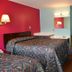 Budget Inn Richlands Claypool Hill room in Cedar Bluff with two beds, desk and mirror