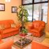Hosteria Maryland in Posadas lobby with orange seating, glass coffee table and large window