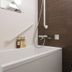 Vessel Inn Hiroshima Station bathroom with tub, shower, toilet, and toiletries in Hiroshima