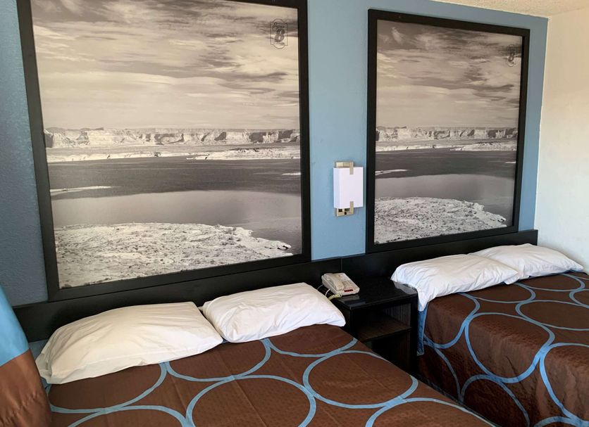 Super 8 by Wyndham Phoenix West room with two beds and framed ocean beach wall art