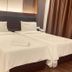 Citi Hotel in Miri twin beds with white linens in a simple guest room