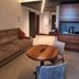 Gasometer Urban Suites Rome suite with sofa, round table, wall TV and kitchenette