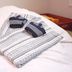 Lodge Koropokkuru in Niseko with folded towels on a bed in a guest room