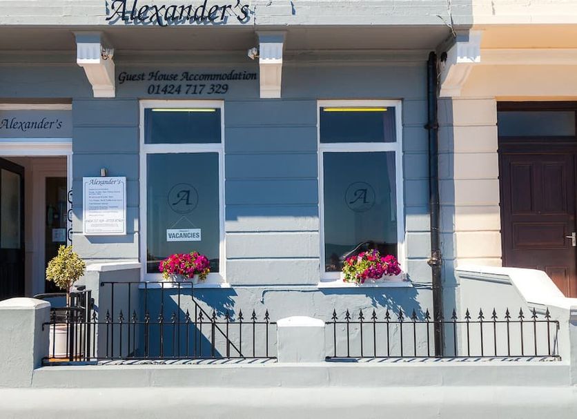 Alexander's in Hastings exterior with blue facade, entrance, windows, and flower boxes