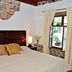 La Ermita de Santa Lucia in Antigua, bedroom with wood headboard, stone accents and garden view