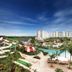 Jpark Island Resort & Waterpark in Lapu-Lapu City with water slides, pools, palm trees and ocean view
