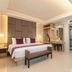 The L Resort, Krabi guest room with king bed, vanity, bench and open wardrobe in Ao Nang