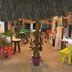 Hotel San Julio in Celestún with colorful chairs under a thatched-roof patio