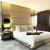Fiesta Residences Boutique Hotel and Serviced Apartments Accra bedroom with large bed and floor-to-ceiling curtains