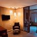 Boutique Hotel Casa Teatro in Manaus room with pendant lights, armchair, and open slatted doorway