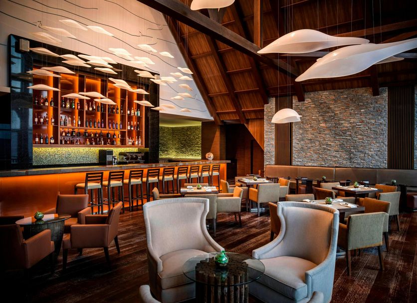 Park Chalet, Shahdag Autograph Collection in Kuzun: stylish lounge with bar, seating, and wood-beam ceiling
