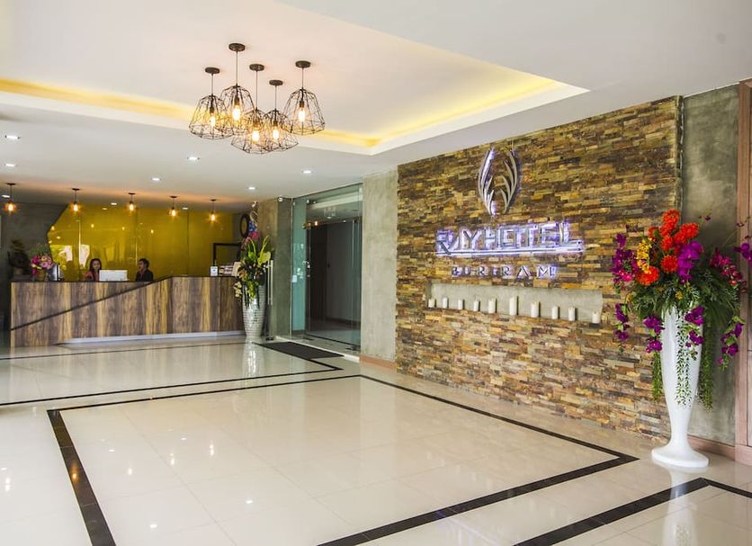 Ray Hotel Buri Ram lobby with reception desk, stone accent wall and modern chandeliers