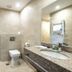Citrus Hotel Tbilisi bathroom with toilet, granite vanity, sink and towel warmers