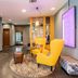 Premier Inn Stuttgart Airport lobby with yellow chairs, ottoman, and wall art in Leinfelden-Echterdingen