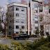 Solo Suites in Victoria, modern multi-story hotel exterior with street view and cherry blossoms