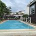 Brisa Marina Beach Resort powered by Cocotel in Morong, outdoor pool surrounded by resort buildings and greenery