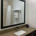 Wingate By Wyndham Jfk Airport / Far Rockaway bathroom vanity with mirror, towels and shower in Queens