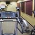 The Q Hotel & Suites Springfield fitness room with treadmills, elliptical machine and wall-mounted TV