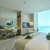 Onyx Rotana Manama guest room with floor-to-ceiling sea view and seating area