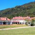 Toyoko Inn Izumo-shi Ekimae in Izumo with red-roofed buildings and a green mountain backdrop