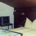 Pension Berggeist in Sölden guest room with double bed, pillows and small TV on a shelf