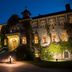 St. Eugene Golf Resort & Casino in Cranbrook, lit historic stone hotel exterior at night with ivy-covered facade
