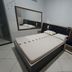 Hotel Flert Santana in Sao Paulo: simple guest room with bed, mirror and tiled floor