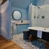 Hotel du Vin Henley bathroom with freestanding tub, walk-in shower and patterned tile in Henley-on-Thames