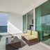 Balcony at Travelers Orange Cartagena in Cartagena with ocean view and glass doors to dining area.