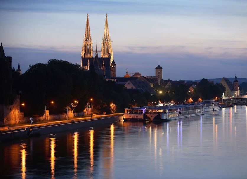 ibis Regensburg City in Regensburg overlooking the Danube River and cathedral spires at dusk