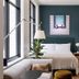 Roost Detroit room in Detroit with a bed, teal accent wall, and large windows beside a sofa
