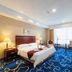 Shenyang Tianbao International Hotel (Zhongjie) room with king bed, desk and window view in Shenyang
