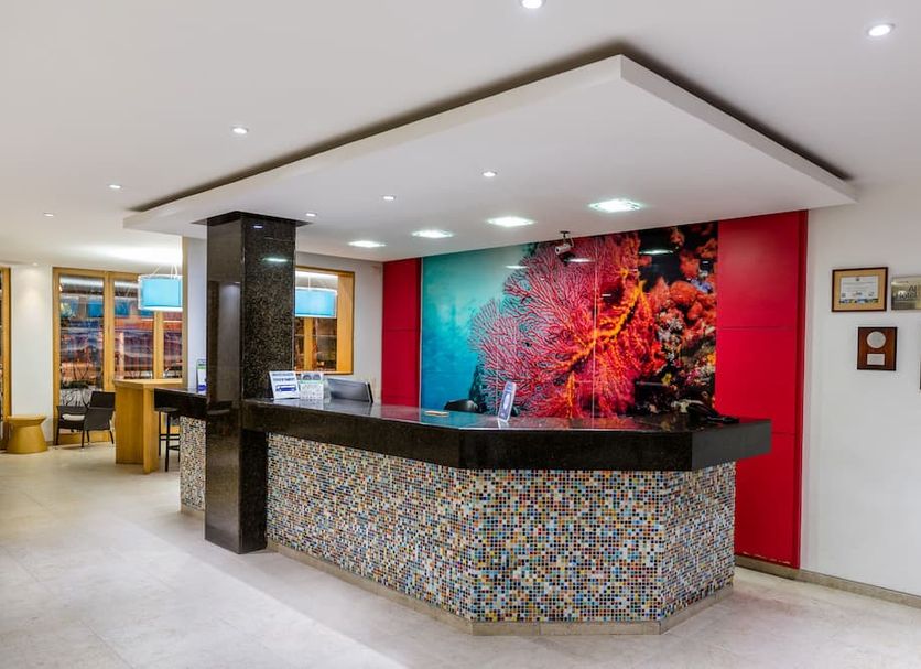 Blu Hotel by Tamaca in Santa Marta lobby with colorful front desk and mosaic counter