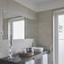 Quinta da Abelheira bathroom vanity with vessel sink, mirror, and door to outside in Ponta Delgada