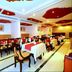 Hotel Sea View in Kanyakumari restaurant with red-accented ceiling and neatly set dining tables