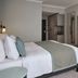 Leonardo Royal Hotel Düsseldorf Königsallee room with king bed, desk, TV and wardrobe in Düsseldorf