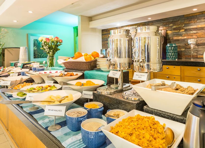 Breakfast buffet at Town Lodge Menlo Park in Pretoria with hot dishes, fruit, and beverage urns