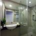 The Aim Patong Hotel bathroom with glass shower, wall-mounted sink and toilet in Patong