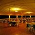 Hotel La Isla in Parrita: open-air dining terrace with tables and chairs under warm lighting